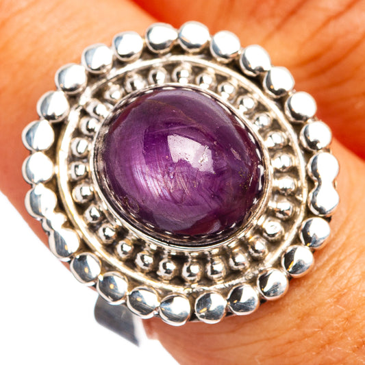 Sterling silver ring with round purple gemstone cabochon and bead halo