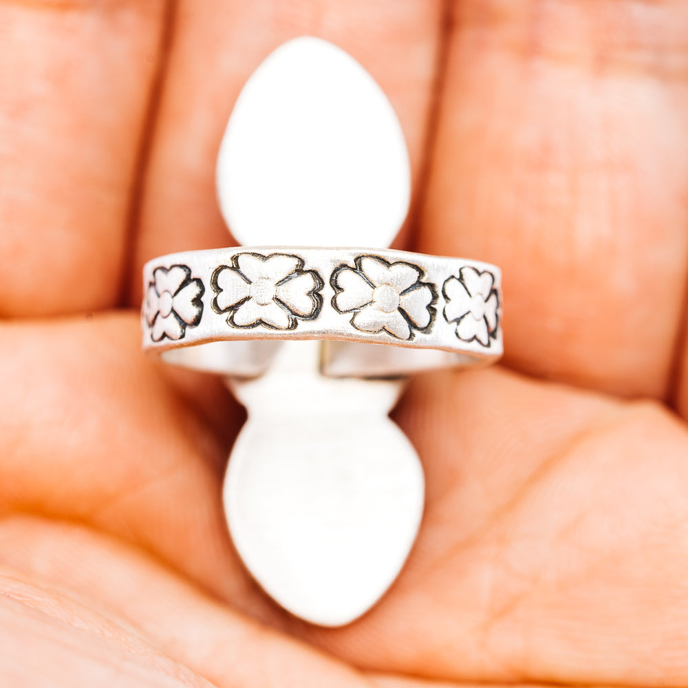 Sterling silver band with embossed clover pattern and smooth inner edge