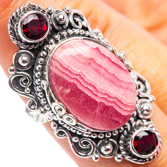 Oval pink rhodochrosite ring in .925 sterling silver with red garnet accents