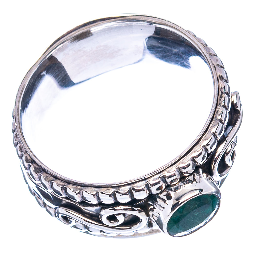 Sterling silver emerald ring with green oval stone, patterned band and open interior