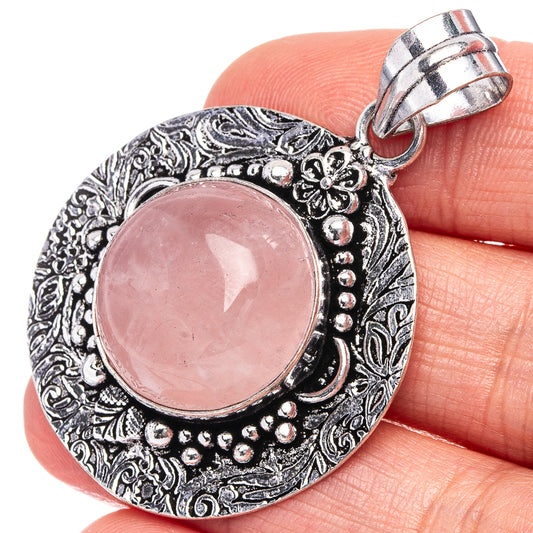 German silver rose quartz pendant with pink oval cabochon and ornate round frame, bail