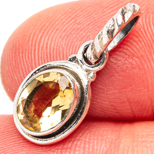 Sterling silver citrine pendant with oval gemstone and ornate bail, close-up