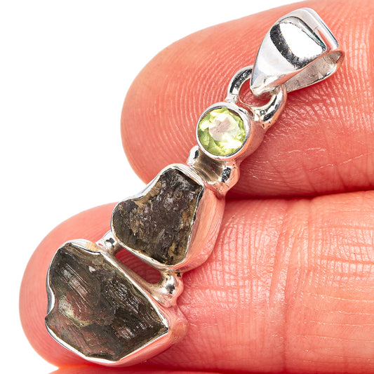 Sterling silver pendant with round peridot and raw dark-green moldavite stone