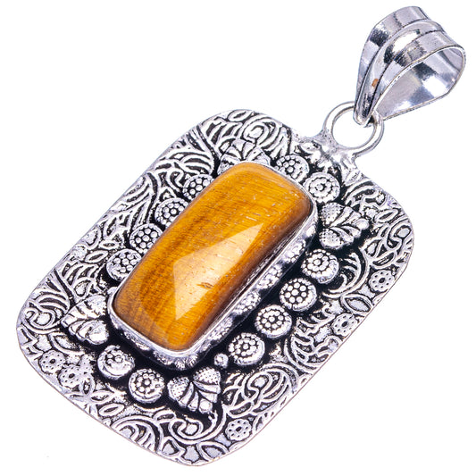 Tiger's eye pendant with tiger-eye cabochon and ornate silver-tone frame