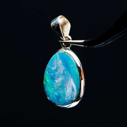 Sterling silver fire opal pendant with teardrop blue-green cabochon, side bezel view