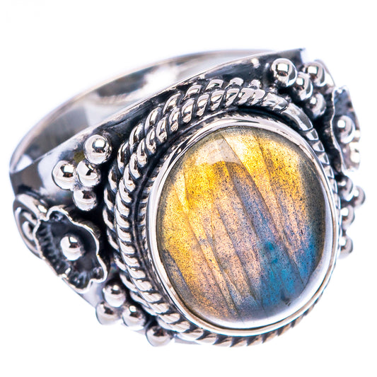 Sterling silver labradorite ring with oval bezel, ornate braided setting, golden-blue glow