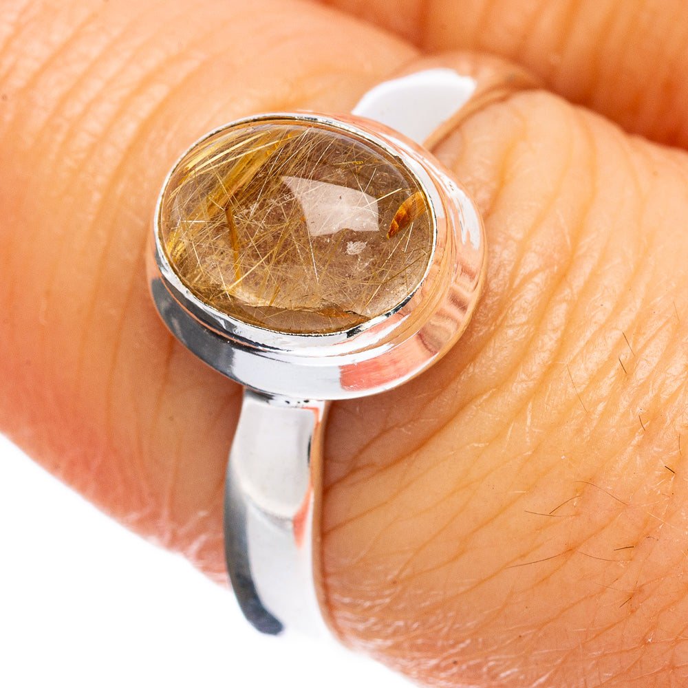 Sterling silver ring with oval rutilated quartz cabochon, golden needles bezel