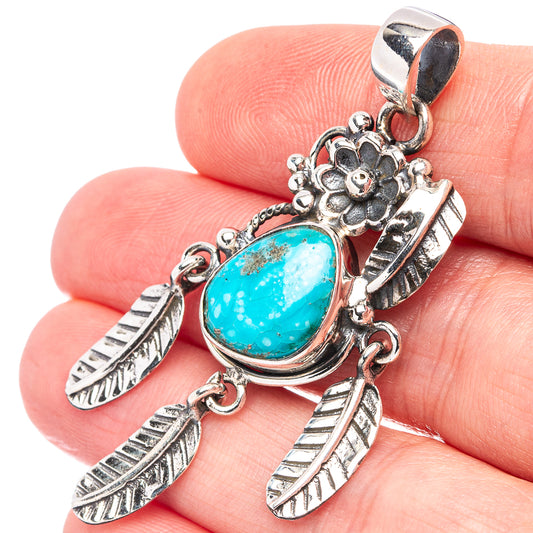 Turquoise oval pendant with sterling silver ornate frame, feather accents, hanging bail