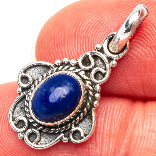 Sterling silver lapis lazuli pendant with oval blue stone and ornate filigree bail