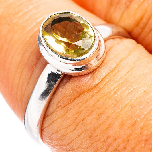 Sterling silver ring with oval faceted lemon quartz gemstone, close-up side view