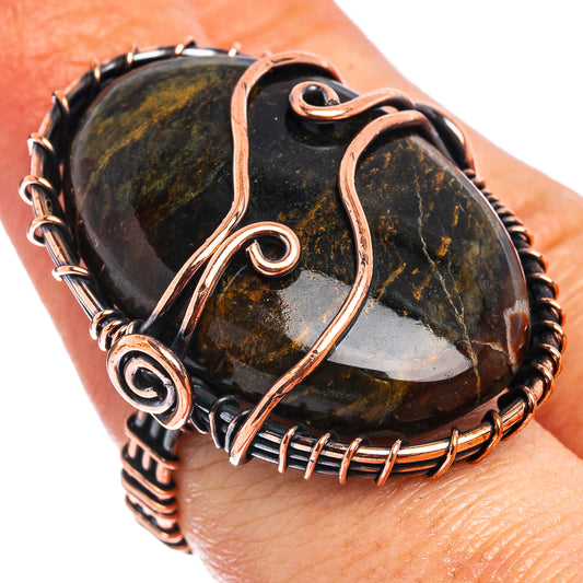 Oxidized copper wire-wrapped ring with dark pietersite oval stone centerpiece