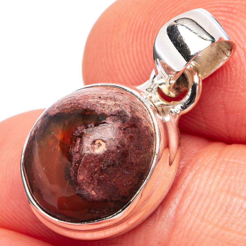 Oval fire opal pendant in sterling silver bezel, red and dark maroon stone