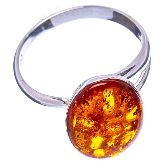 Round amber cabochon set in .925 sterling silver ring, bright orange stone