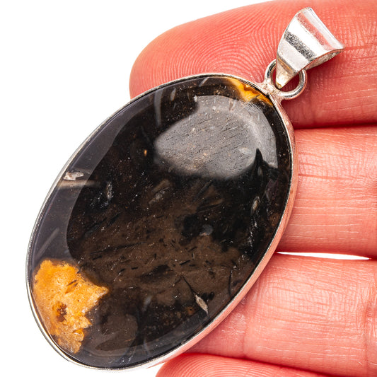 Silver-plated black banded agate oval pendant with orange-yellow mineral bands