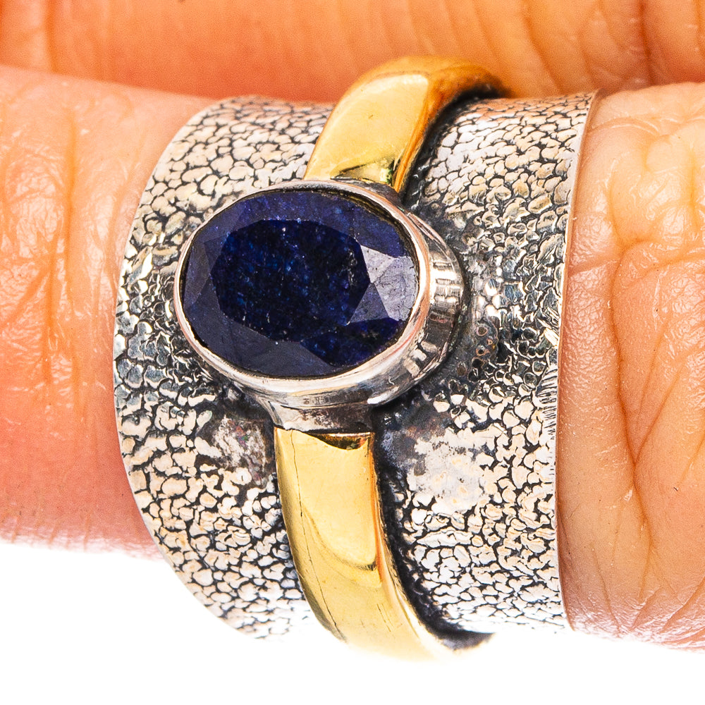 Sterling silver ring with blue oval gemstone and hammered texture, gold-toned side accents