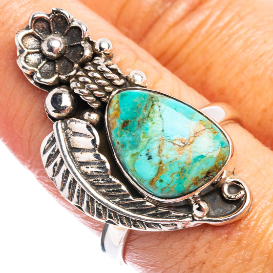 Turquoise teardrop sterling silver ring with detailed flower motif and bead accents