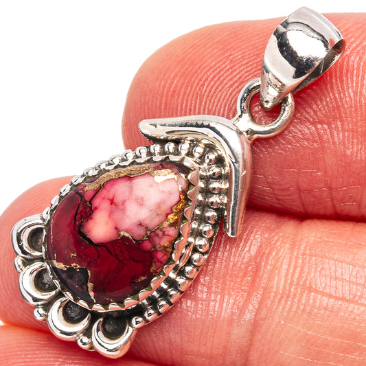 Sterling silver pendant with oval red-pink stone and ornate bezel, top loop bail