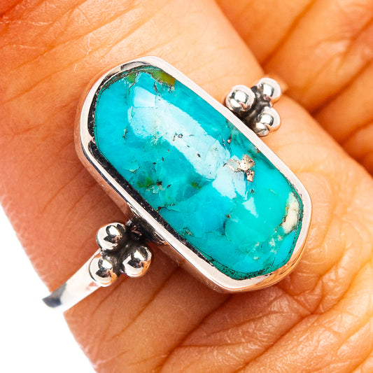 Turquoise oval sterling silver ring with raised bezel and bead accents on band