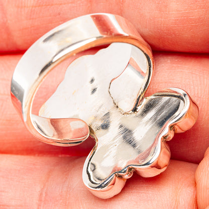 Adjustable silver ring with open back and smooth polished band, stones not visible
