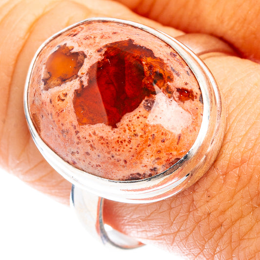 Oval fire opal cabochon set in sterling silver ring, close-up top view