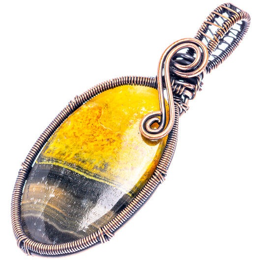 Oval jasper wire-wrap pendant in oxidized copper, yellow center with dark stripe