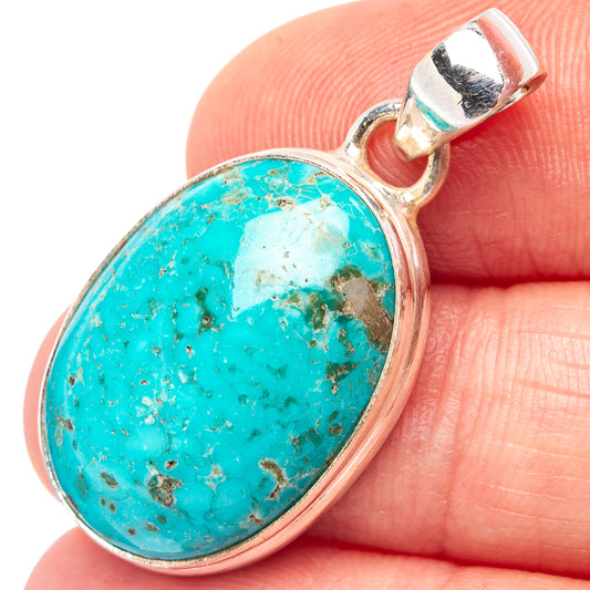 Turquoise oval pendant with .925 sterling silver bezel and clasp bail, close-up view