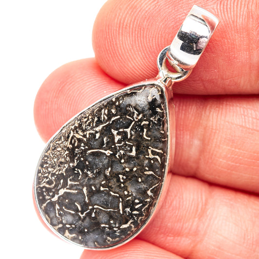 Dinosaur bone pendant, teardrop shape, .925 sterling silver bezel, black speckled texture