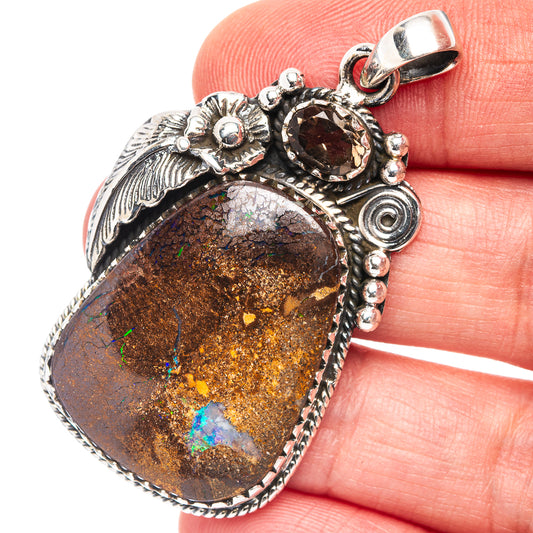 Sterling silver boulder opal pendant, teardrop setting with iridescent blue-green flashes