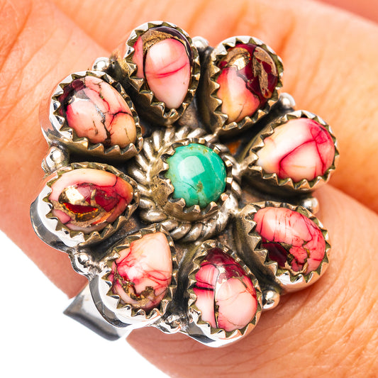 Native-style ring top view, red oval stones around a bright turquoise centerpiece