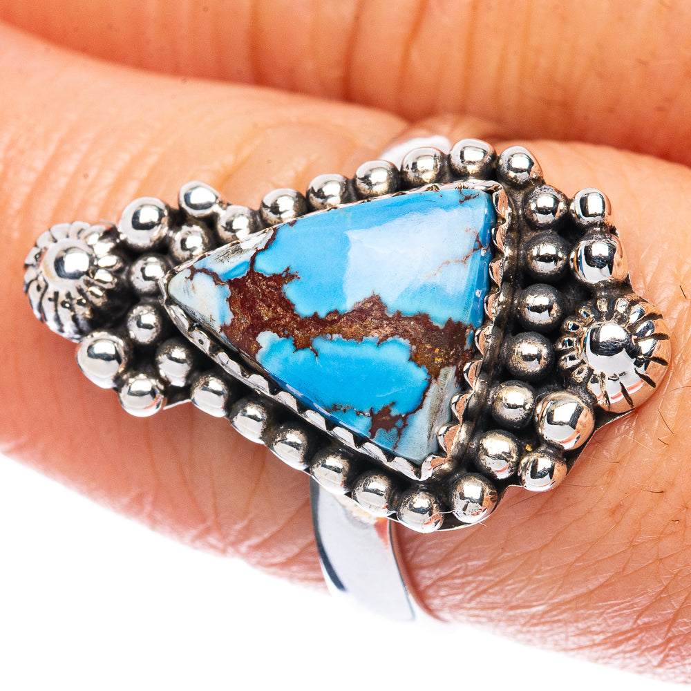 Sterling silver turquoise ring on finger with oval cabochon and raised beadwork