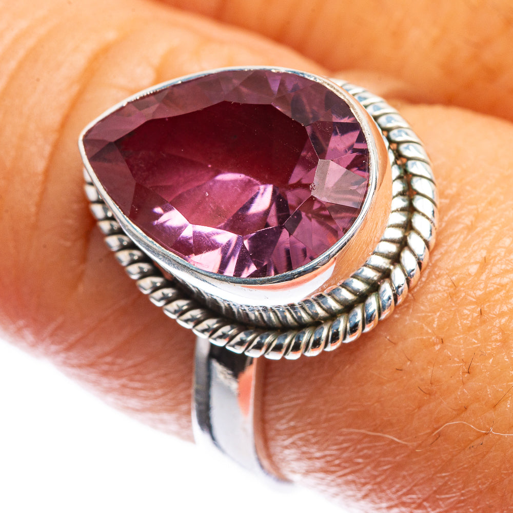 Sterling silver ring with oval faceted purple gemstone, braided halo setting