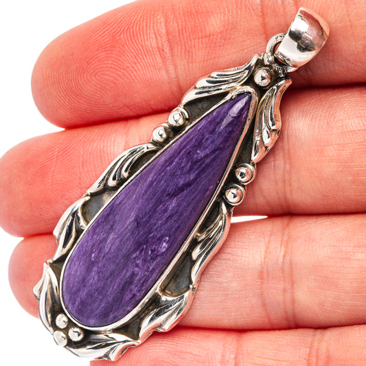 Charoite teardrop pendant in .925 sterling silver with ornate bezel and round accents
