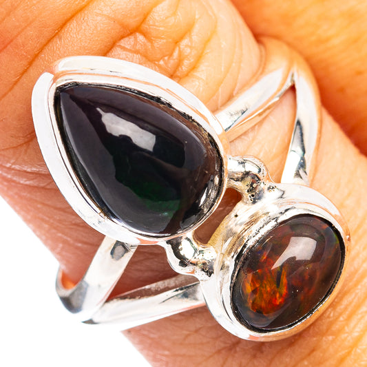 Sterling silver ring with black oval cabochon and small amber cabochon accents