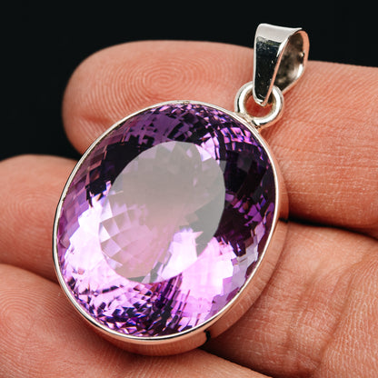 Oval amethyst pendant with faceted purple stone in .925 sterling silver bezel
