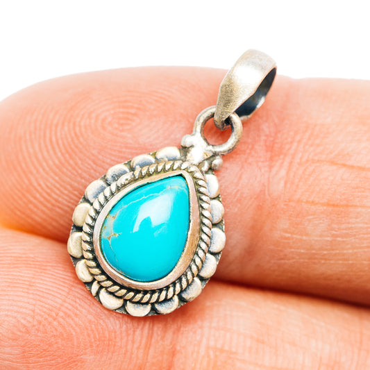 Turquoise teardrop pendant with silver rope bezel and scalloped border
