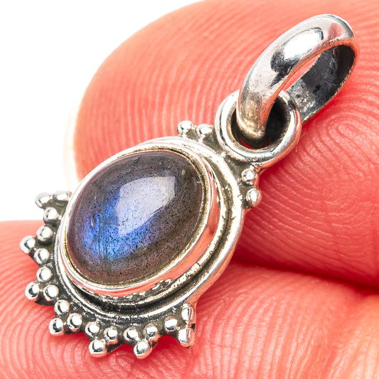 Oval labradorite pendant in .925 sterling silver with blue flash and beaded edge, close-up