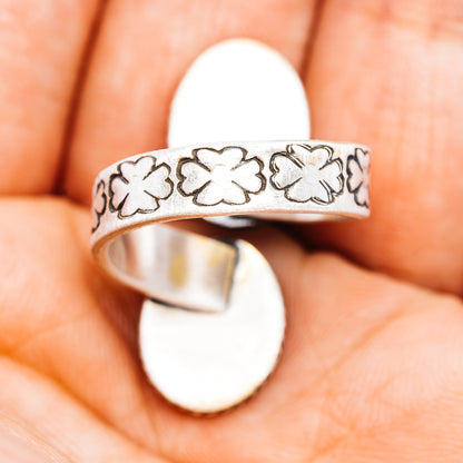 Sterling silver ring band with raised floral cutout pattern, oval yellow cabochon