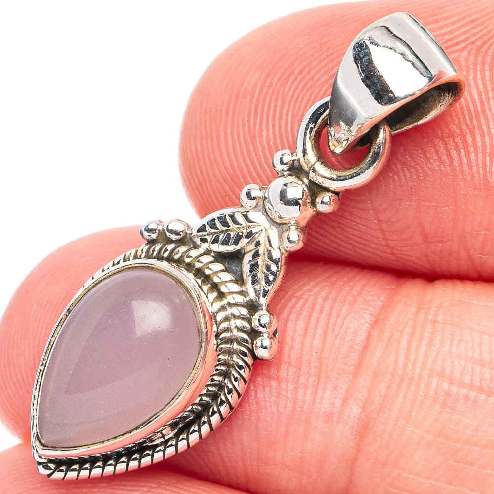 Oval rose quartz pendant in 925 sterling silver with decorative bail and bead accents