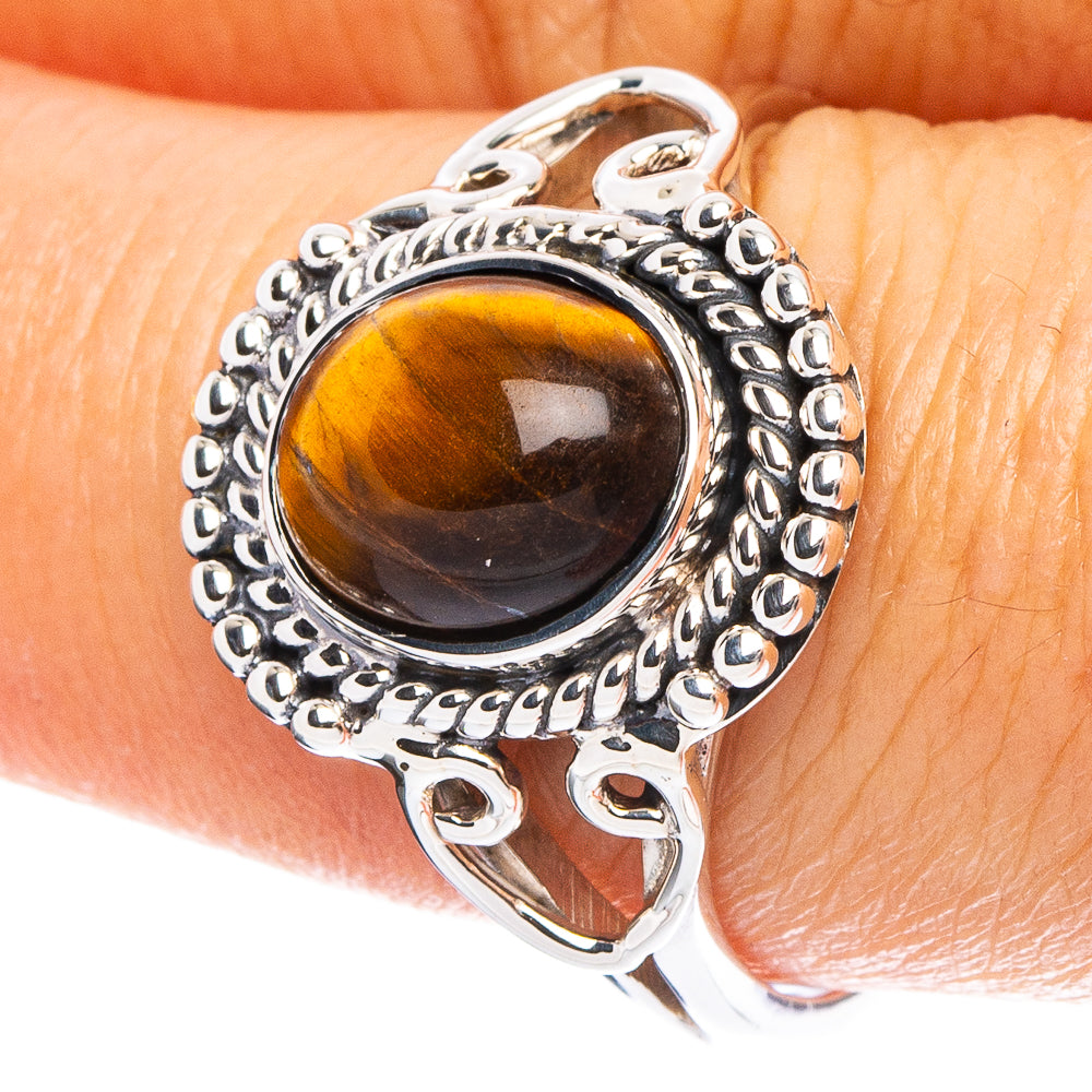 Silver ring with round tiger eye gemstone and ornate halo setting