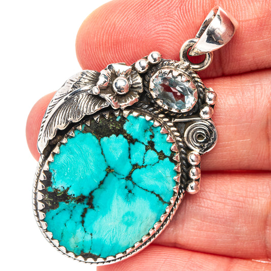 Turquoise teardrop pendant in ornate .925 sterling silver with leaf accents and loop bail
