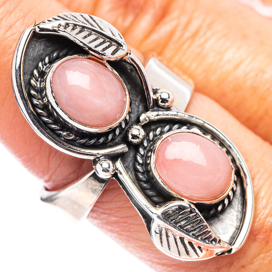 Adjustable .925 sterling silver ring with two oval pink opal cabochons.