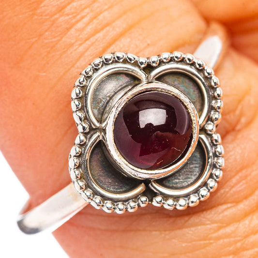 Sterling silver garnet ring with maroon oval stone in heart-shaped setting