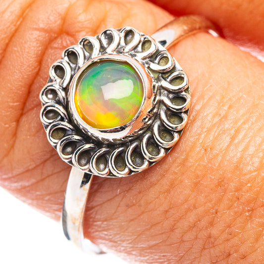 Sterling silver opal ring with oval iridescent green-yellow gemstone halo