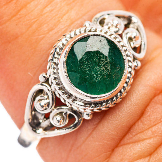 Sterling silver ring with round green gemstone, ornate filigree and small accent stones