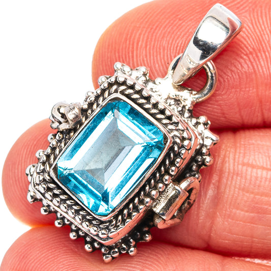 Sterling silver topaz pendant closeup with square blue gemstone bezel and loop bail