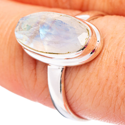 Sterling silver moonstone ring, oval stone with pale blue iridescence on finger