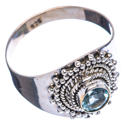 Sterling silver band ring with blue stone set on ornate raised bead cluster