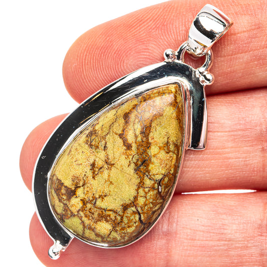 Sterling silver gaspeite teardrop pendant with yellow-brown stone and silver frame