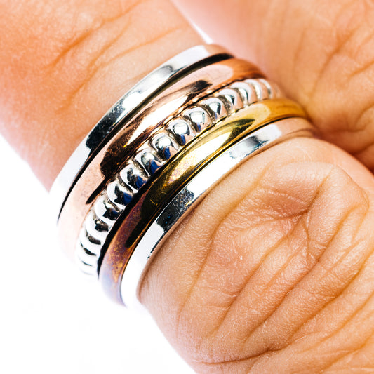 Spinner ring in polished .925 sterling silver, with blue and gold inlay accents; size 6.75