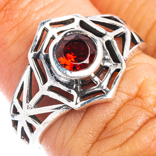 Sterling silver dainty ring with red garnet center and ornate web-like design